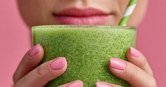 Close-up of a woman holding a creamy green spirulina smoothie in a glass with both hands, illustrating healthy spirulina smoothie ideas for a nutritious daily breakfast or snack.