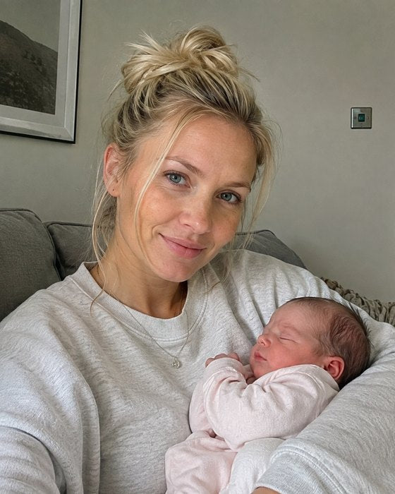 Mother holding her baby at home